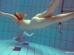 FuckingChickas presents: Redhead goes for a nude swim in the pool