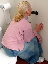 FuckingChickas presents: Blonde girl Jamie sits on the toilet and blows a black gloryhole dong